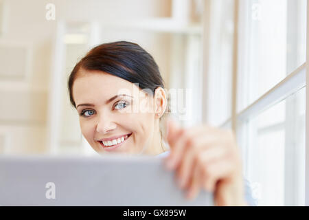 Successful young woman with tablet working in office Stock Photo