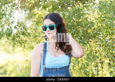 Portrait of beautiful teen girl with sunglasses on head Stock