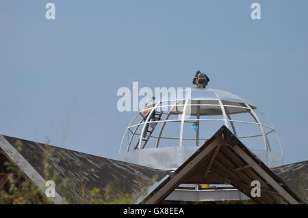 Two workers in metal roof structure. Stock Photo
