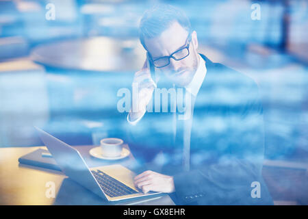 Businessman calling in cafe Stock Photo