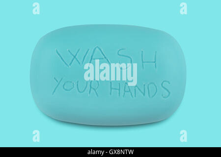 Top view of a blue soap bar with the words wash your hands scratched on it Stock Photo