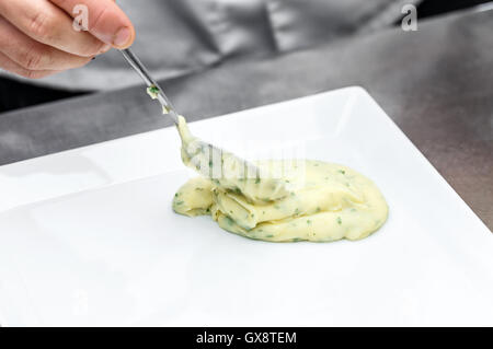 Chef garnishing a plate, mashed potatoes Stock Photo