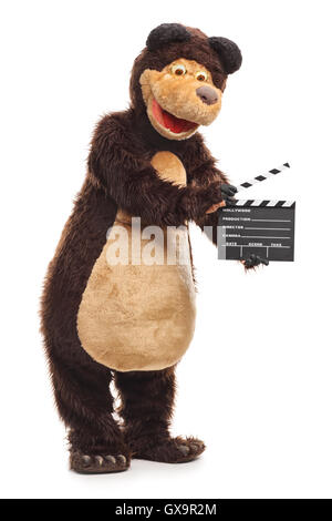 Guy dressed in a bear costume holding a clapperboard isolated on white background Stock Photo