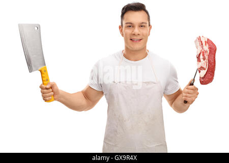 Young butcher holding a cleaver and a fork with a steak isolated on white background Stock Photo