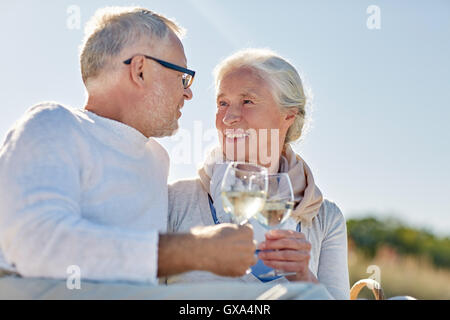 happy senior couple having picnic on summer beach Stock Photo