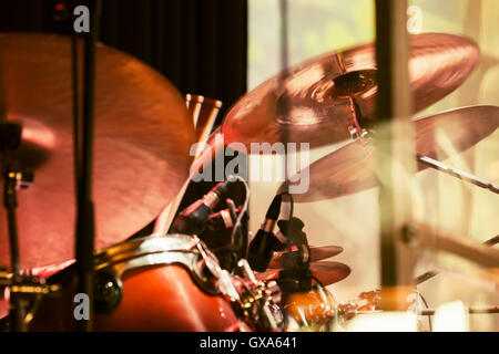 Vintage toned rock music blurred photo background, drummer plays on cymbals, old instagram style Stock Photo