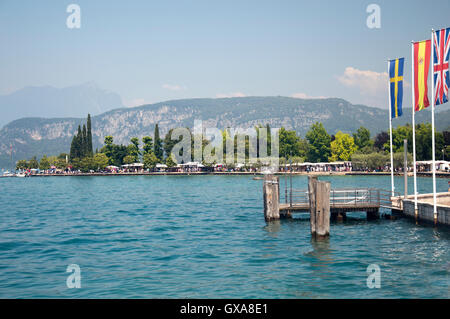 Swedish, Spanish and British flags flying side by side, Bardolino, Italy Stock Photo