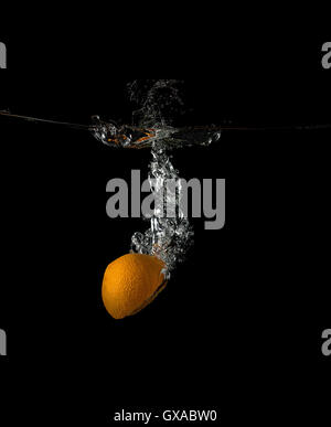 orange under water on a dark background Stock Photo
