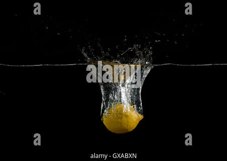 Lemons are falling into the water holding up a lot of splashing Stock Photo