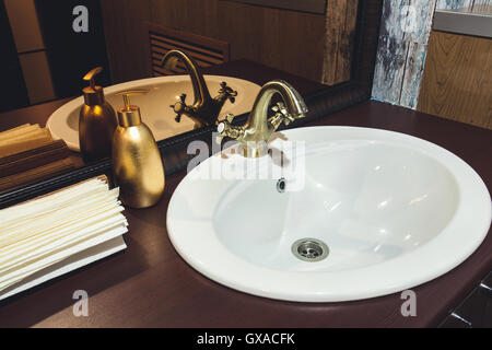 bronze faucet in the bathroom washstand Stock Photo