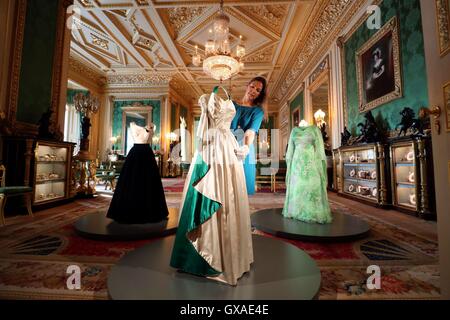 Curator Caroline de Guitaut arranges an evening gown worn by The Queen, in the Green Drawing Room during a press preview for Fashioning a Reign: 90 Years of Style from the Queen's Wardrobe, an exhibition at Windsor Castle in Berkshire. Stock Photo