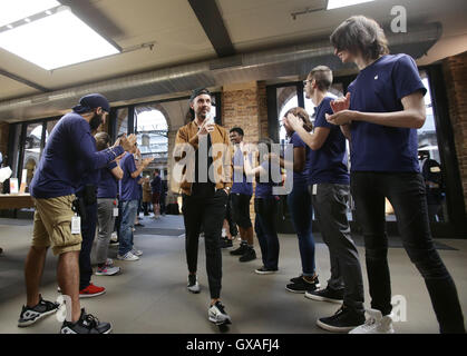 Staff greet the first customers for the new iPhone 7 at the Apple store in Covent Garden, London. Stock Photo