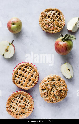 Mini apple pies, decorated with lattice and roses from dough. Top view. Copy paste Stock Photo