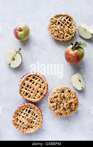 Mini apple pies, decorated with lattice and roses from dough. Top view. Copy paste Stock Photo