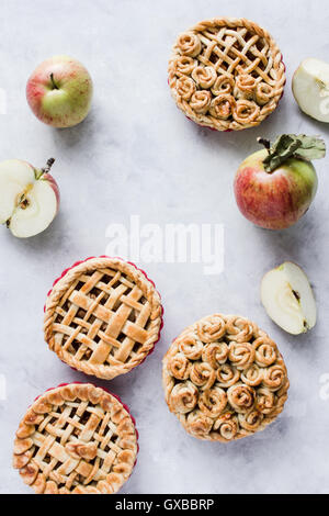 Mini apple pies, decorated with lattice and roses from dough. Top view. Copy paste Stock Photo