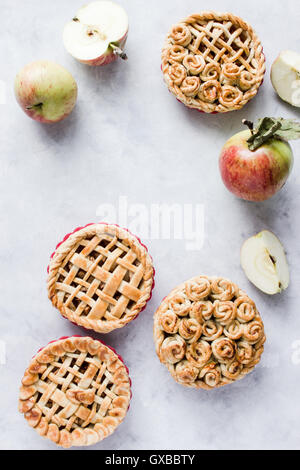 Mini apple pies, decorated with lattice and roses from dough. Top view. Copy paste Stock Photo