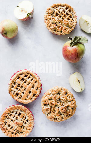 Mini apple pies, decorated with lattice and roses from dough. Top view. Copy paste Stock Photo