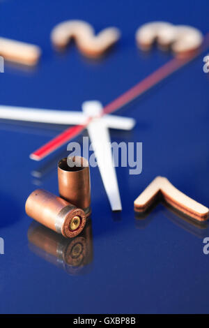 Deadline concept. Pair of gun cases standing on clock face Stock Photo