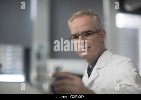 Male meteorologist examining microscope slide in weather station laboratory Stock Photo