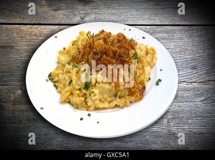 Spaezle, typical Bavarian plate of homemade pasta and cheese with fried onions on top served at open air restaurants Stock Photo