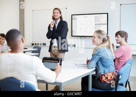 Male lecturer questioning students in higher education college classroom Stock Photo