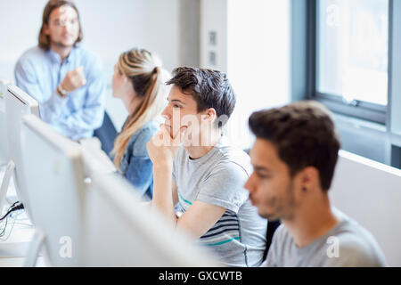 Students working on computers in higher education college computer room Stock Photo