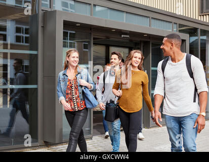 Male and female students leaving higher education college Stock Photo