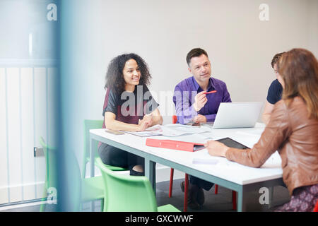 Designers having meeting at design studio boardroom table Stock Photo