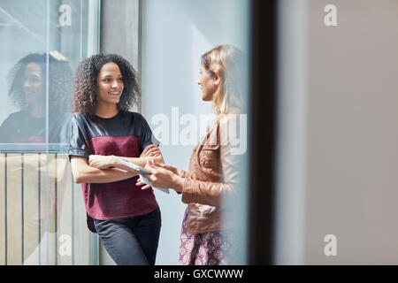 Two female designers chatting in design studio Stock Photo