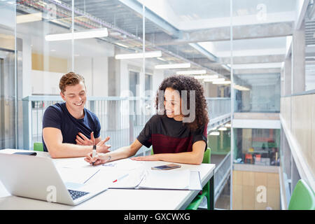 Male and female designers brainstorming in design studio Stock Photo