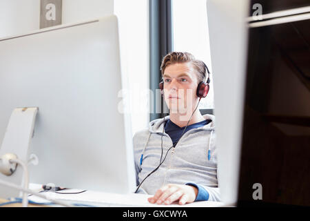 Young male computer aided designer working on computer in design studio Stock Photo