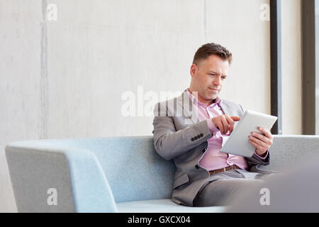 Businessman using digital tablet touchscreen in office Stock Photo