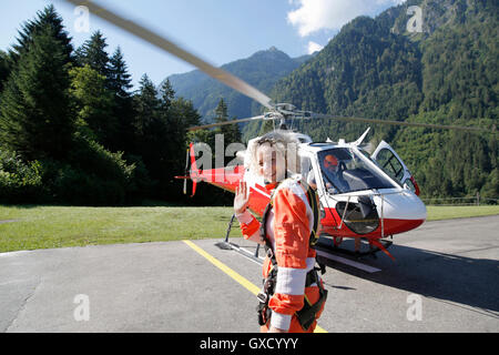 First time female tandem sky diver getting ready for helicopter, Interlaken, Berne, Switzerland Stock Photo