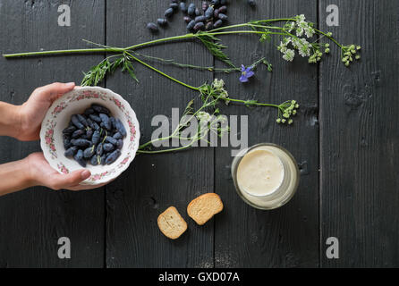 Overhead view of man's hands holding bowl of berries Stock Photo