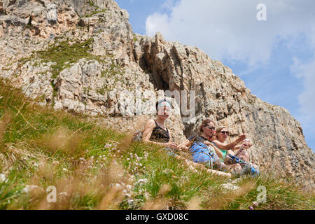 Hikers resting on rocky hillside, Austria Stock Photo