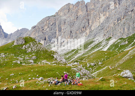 Hikers resting on rocky hillside by mountain, Austria Stock Photo