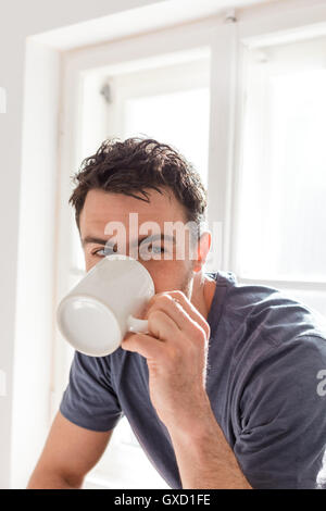 Man drinking from mug Stock Photo
