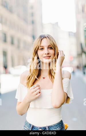 Portrait of young woman, blonde hair, outdoors Stock Photo