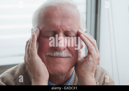Senior man suffering from headache Stock Photo