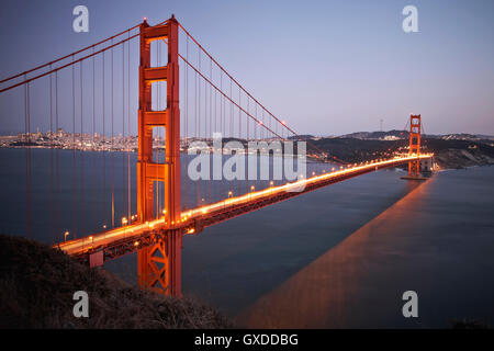 View of traffic light trails crossing Golden Gate Bridge at dusk, San Francisco, California,  USA Stock Photo