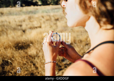 Over shoulder view of woman using compass Stock Photo