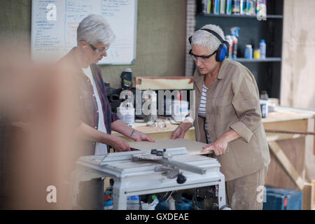 Female carpenters preparing wood in furniture making workshop Stock Photo