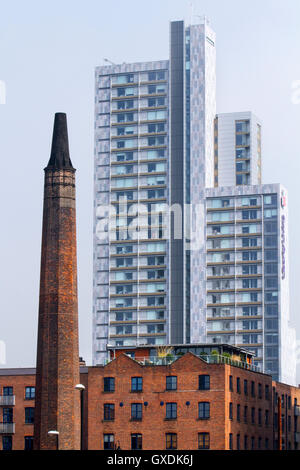 Chorlton Mill and attached chimney and Residential accommodation and high-rise buildings in the Castefield area of 1st Street near Salford, Manchester, UK Stock Photo