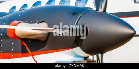 Panoramic view of a black turbo-prop engine and propeller blades of a modern aircraft against the background of a main body Stock Photo