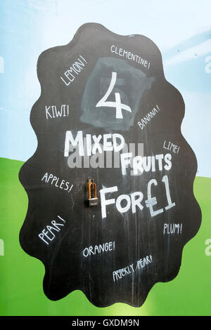 A '4 mixed fruits for £1' sign on side of street fruit and veg stall Stock Photo