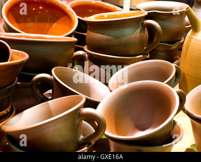 Handmade traditional russian ceramics (crockery, things, ware, jugs, pots) on the shopboard at the flea market in Moscow, Russia Stock Photo