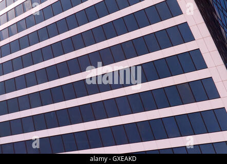 Cotemporary architecture concept background: abstract modern business building facade which represents a wall of glass windows Stock Photo