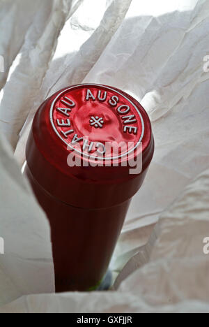 Close view on unwrapped bottle with encapsulation foil seal of fine luxury Chateau Ausone Saint-Émilion red wine Bordeaux France Stock Photo