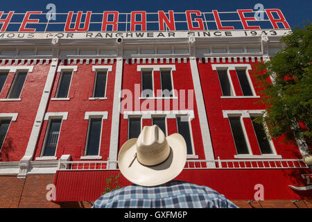 A cowboy looks up at the Wrangler western wear store  July 23, 2015 in Cheyenne, Wyoming. The store opened in 1943 is the largest western wear outfitter in America. Stock Photo