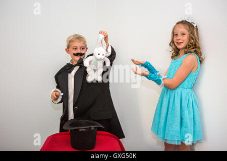Magician pulling out a rabbit from his top hat Stock Photo - Alamy